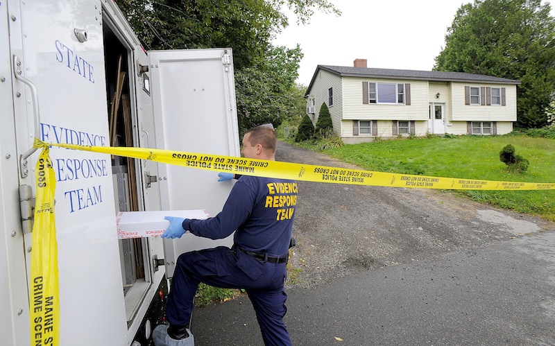 A state police evidence technician enters a state police mobile lab at 162 Waldo Ave. in Belfast on Thursday, Aug. 29, 2013. Belfast resident Todd Gilday had been charged with murdering Lynn Arsenault, 55, and wounding her son, Mathew Day, 21, at their home seen here.