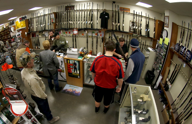 Customers line up at the gun counter at Duke's Sport Shop in New Castle, Pa. A new study finds that thousands of guns are being sold on the Internet, where buyers don't have to submit to a background check, as they would at retail stores.