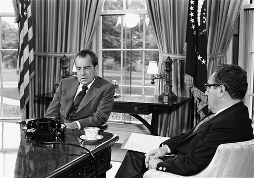 President Richard Nixon talks with Secretary of State Henry Kissinger about the Middle East during a meeting at the White House in October 1973.