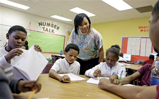 In this April 18 file photo, Burgess-Peterson Elementary School principal Robin Robbins, center, meets with students during an after-school study program in Atlanta, in preparation for state standardized testing, soon to begin. A new poll from the Associated Press-NORC Center for Public Affairs Research finds parents of school-age children view standardized tests as a useful way to track student progress and school quality.