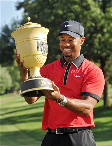 Tiger Woods holds the trophy after winning the Bridgestone Invitational on Sunday at Firestone Country Club in Akron, Ohio. Woods' 15-under par won by seven shots.