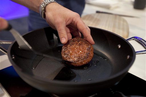 A new Cultured Beef Burger made from beef grown from stem cells is cooked by chef Richard McGeown during the world's first public tasting event for the food product held in London on Monday.