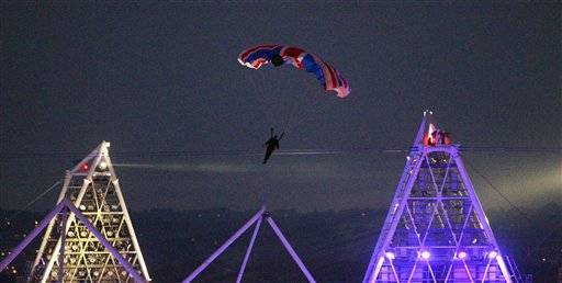 In this July 27, 2012, photo, stuntman Mark Sutton, dressed as James Bond, parachutes into the Olympic Stadium during the opening ceremony.