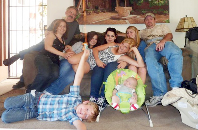 In this June 2011 file photo provided by Andrea Saincome, Hannah Anderson, center, reclining across the laps of others, and James Lee DiMaggio, right, pose for a picture with other members of the extended Anderson and Saincome families. Via a social media site, Hannah Anderson says longtime family friend DiMaggio “tricked” her into visiting his house, tying up her mother and younger brother in his garage before escaping with her to the Idaho wilderness. Anderson says she cried all night after being rescued and learning that her family members were found dead at DiMaggio's burning house. Seated from left are: Christina Anderson; Christopher Saincome; Christina's sisters Samantha Saincome and Andrea Saincome; their niece Hannah Anderson, reclining; Alexi (last name unavailable, friend of Hannah's), and DiMaggio. On the floor are Ethan Anderson, left, and Andrea's infant child, whose name was not provided. (AP Photo/Courtesy of Andrea Saincome, File)