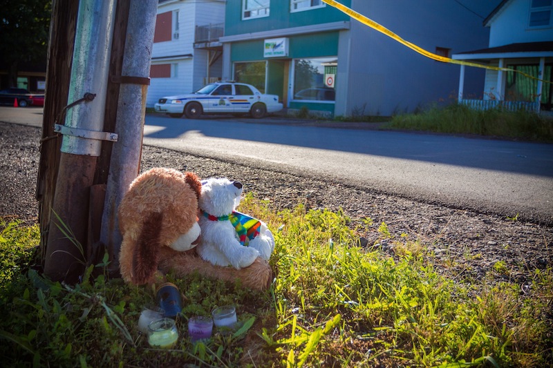 A memorial sits outside the Reptile Ocean exotic pet store in Campbellton, New Brunswick, Canada, on Tuesday, Aug. 6, 2013. Preliminary results from autopsies performed on the boys show they died from asphyxiation, officials said Wednesday. The shocked community planned a vigil Wednesday. (AP Photo/The Canadian Press, John LeBlanc)