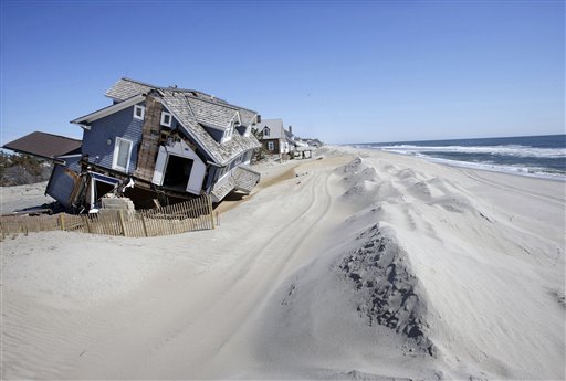 In this April 25, 2013, file photo, homes severely damaged last October by Superstorm Sandy, are seen along the beach in Mantoloking, N.J.