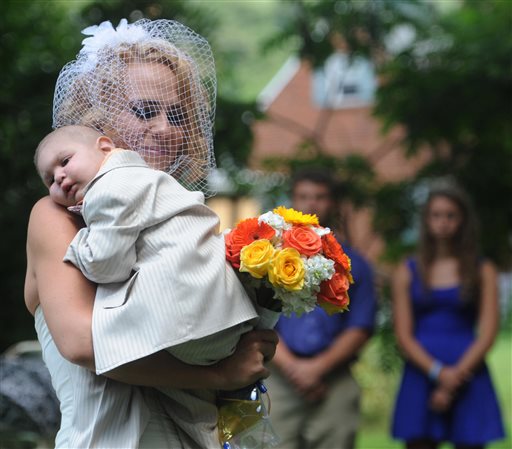 Christine Swidorsky carries her son and the couple's best man, Logan Stevenson, 2, down the aisle to her husband-to-be Sean Stevenson during the wedding ceremony in Jeannette, Pa. on Aug. 2. Christine Swidorsky Stevenson says on her Facebook page that Logan died in her arms at 8:18 p.m. Aug. 5, at their home in Jeannette, about 25 miles east of Pittsburgh.