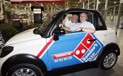 In this July 6, 2012, photograph, former Mississippi Gov. Haley Barbour, left, and then-GreenTech Automotive chairman Terry McAuliffe take a drive through the plant after the unveiling of the company's new electric MyCar in Horn Lake, Miss. Today, the place where the plant was to be remains mostly vacant except for a temporary construction trailer. The company is under investigation by the Securities and Exchange Commission.