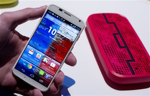 The Motorola Moto X smartphone uses Google's Android software. In the background is a Deck, from Sol Republic, which is a wireless speaker that operates up to 300 feet from the phone using Bluetooth technology.