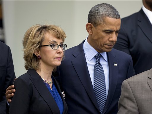 In this April 17, 2013, photo, President Barack Obama puts his arm around former Arizona Rep. Gabrielle Giffords before speaking in the Rose Garden about measures to reduce gun violence.