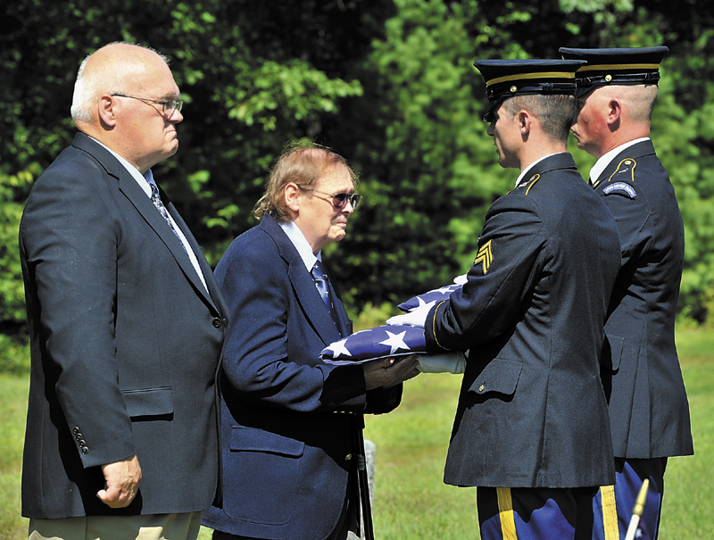 On Thursday, a Memorial was held at the Pleasant Ridge Cemetery in Hiram for four servicemen killed in past wars. Francis William Lyons, Jr. and Donald Gray, Jr. receive the folded flags from Sgt. Casey Lawrence, left, and Sgt. David Chabe of the Maine National Guard, members of the Maine Military Funeral Honors Program.