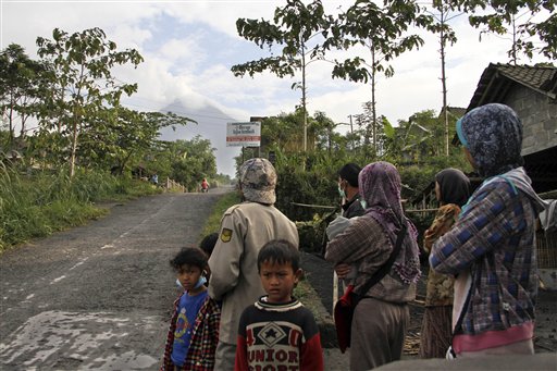 Villagers look at Merapi volcano Cangkringan, Indonesia, on Monday.