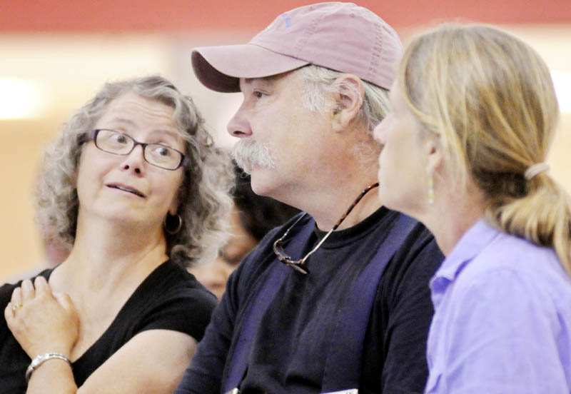 Farmers Lisa, left, and Ralph Turner, of Laughing Stock Farm in Freeport, and Jan Goranson, of Goranson Farm in Dresden, listen to Food and Drug Administration Deputy Commissioner of Food Safety Michael Taylor speak today in Augusta about the Food Modernization Act, which would impose new rules for farmers to reduce foodborne illness.