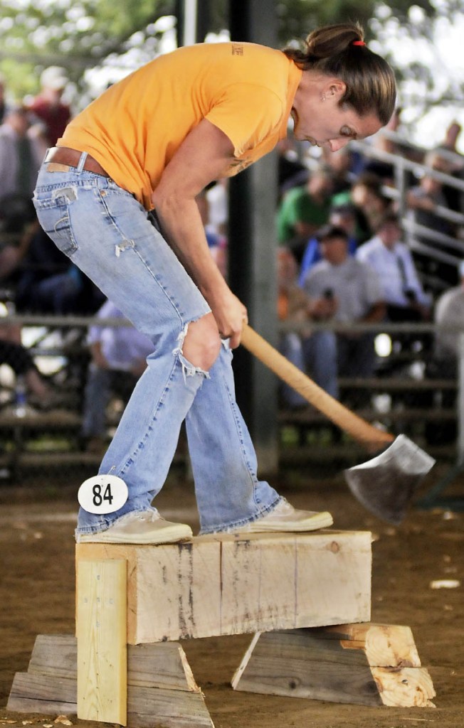 Michelle Morse competes in a wood cutting event today during the Windsor Fair Woodsmen's Field Day. Morse, of Eastbrook, is the world champion in the lumberjill standing block chop competition.