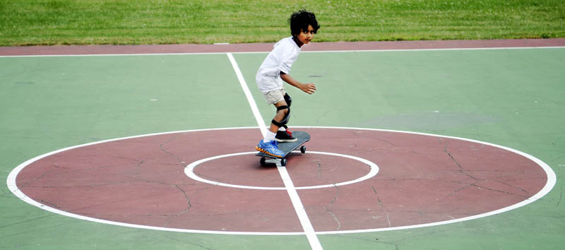 Aryan Das, 6, skates across center court today at Williams Playground in Augusta. The Augusta resident graduated from a scooter this week to roll without handle bars on the skateboard, according to his father, Anupam Das. "I like it now," the younger Das said.