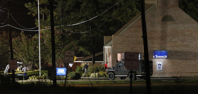 Investigators work throughout the early morning hours Wednesday, Aug. 14, 2013 at the Tensas State Bank branch in St. Joseph, La., where a gunman took three people hostage Tuesday. A second hostage shot during the standoff died Thursday at a hospital. (AP Photo/Rogelio V. Solis)
