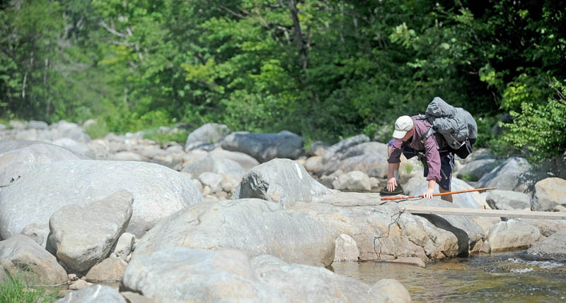 Jonathan Eaton, 54, of Warrenton, Va., crosses the Carrabassett River while thru-hiking the Appalachian Trail, in Wyman Township on Thursday. This section of trail intersects Route 27 in Wyman Township, where missing Tennesse hiker Geraldine Largay was scheduled to meet her husband, George, on July 24. She never made it for the scheduled rendezvous.