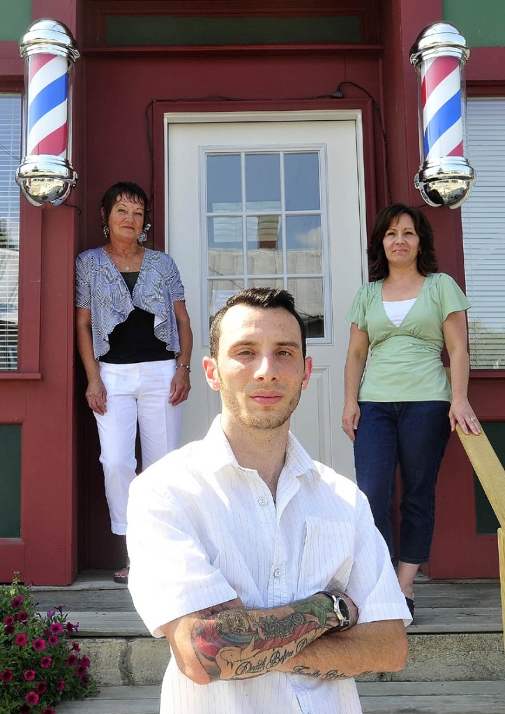 Derrik Vigue, foreground, a third-generation hair stylist in his family, poses for a portrait with his mother, Renee Vigue, back right, and grandmother, Dianne Scott, back left, both hairstylists, in front of his barber shop, Faded Lines Barber Shop, at 99 Church St. in Oakland on Thursday. Derrik recently opened his own salon and is getting expert advice and help from his mother and grandmother.