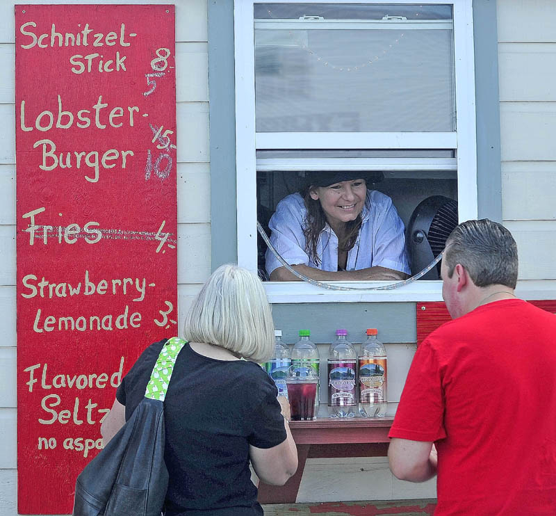 Johanna Franz, of Trescott, serves customers at her Sunny-Waters Grille cart at the 195th annual Skowhegan State Fair at the Skowhegan Fairgrounds today. Franz's cuisine celebrates her German-American heritage.