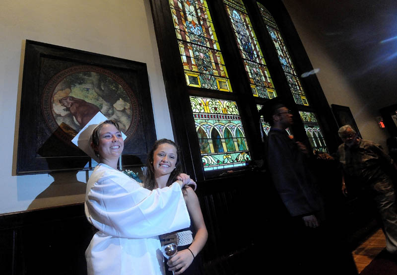 Emily Baker, left, and Zoe Keiper, 15, right, pose for a picture in Moody Chapel before the inaugural commencement of the Maine Academy of Natural Sciences today in Hinckley.
