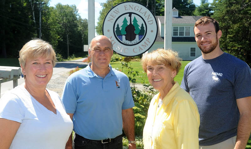 Jeanette Wiggin, director emeritus, second from right, with her grandson, Matthew, right; son, John, left center; and daughter-in-law, Kim, far left, at the entrance to the family's New England Music Camp in Sidney. The music camp has lasted over four generations in the Wiggin family and is wrapping up its 77th summer.