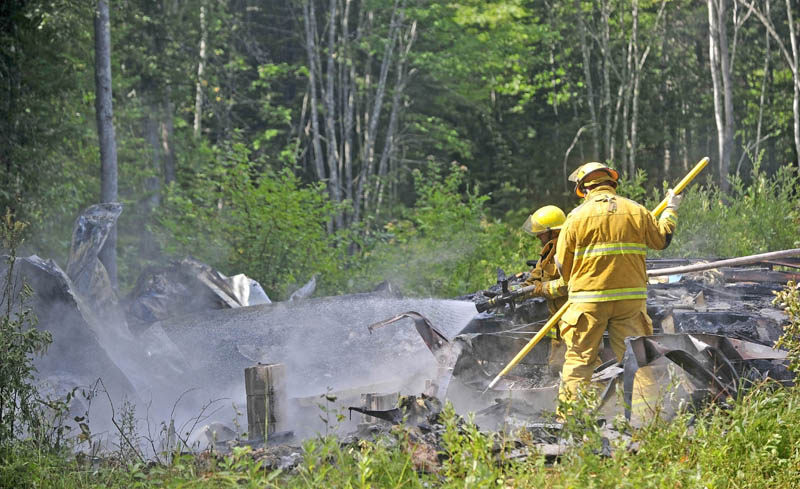 Firefighters from Burnham and Unity mop up a mobile home fire on Pond Road in Burnham today.