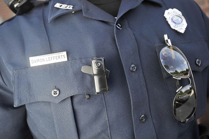 A small video camera is clipped to the right chest pocket of Waterville police officer Damon Lefferts' uniform.