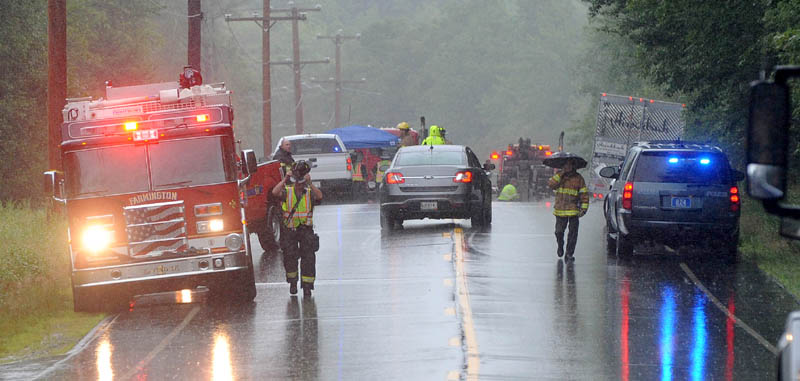 Authorities at the scene of a fatal accident involving a car and tractor trailer on Route 27 in New Vineyard on Friday.