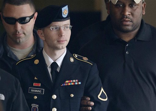 Army Pfc. Bradley Manning is escorted to a security vehicle outside a courthouse in Fort Meade, Md., in this Aug. 20, 2013, photo. He has since changed his name to Chelsea.