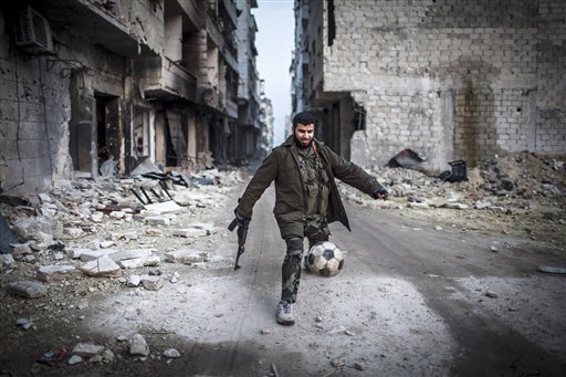 In this Jan. 2 file photo, a Syrian rebel plays soccer in the Saif al-Dawlah neighborhood of Aleppo, Syria. For Syria's banned Muslim Brotherhood, the uprising against President Bashar Assad that erupted amid Arab Spring revolts in 2011 provided a long-sought opportunity to stage a comeback after decades spent in exile.