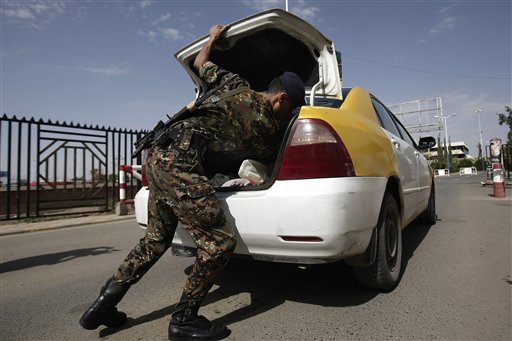 A policeman checks a car at the entrance of Sanaa International Airport, in Yemen on Wednesday. The State Department on Tuesday ordered non-essential personnel at the U.S. Embassy in Yemen to leave the country.