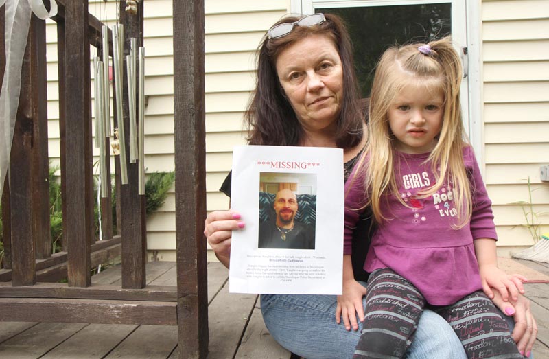 Rosanne Dubay, with her 3-year-old granddaughter, Arrienna Bowring, holds a photo of her missing son, Vaughn Giggey III, at her home in Skowhegan today. Several law enforcement agencies, along with friends and family, are looking for Giggey, who was last seen Friday night.