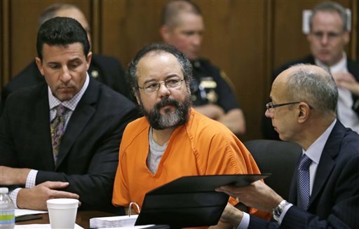 Ariel Castro listens during the sentencing phase of his trial on Thursday in Cleveland. Defense attorney's Craig Weintraub, left, and Jaye Schlachet sit beside Castro.