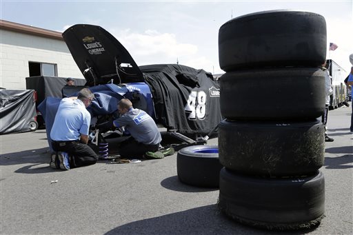 Crew members work on NASCAR Sprint Cup series driver Jimmie Johnson's main car during practice for the Pure Michigan 400 auto race at Michigan International Speedway in Brooklyn, Mich., Saturday, Aug. 17, 2013. Johnson crashed his primary car during practice. (AP Photo/Paul Sancya)