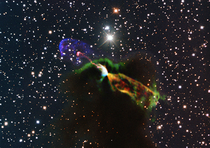 This image made available by the European Southern Observatory using radio and visible light frequencies shows the Herbig-Haro object HH 46/47. The orange and green, lower right, reveal a large energetic jet moving away from the Earth. To the left, in pink and purple, another jet is seen, streaming partly toward the Earth.
