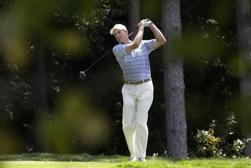 Jim Furyk watches his tee shot on the fourth hole during the first round of the PGA Championship golf tournament at Oak Hill Country Club, Thursday, Aug. 8, 2013, in Pittsford, N.Y. (AP Photo/Charlie Neibergall)