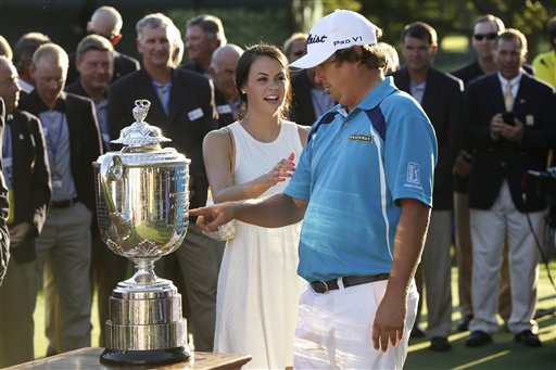 Jason Dufner looks at the Wanamaker Trophy with his wife Amanada after winning the PGA Championship on Sunday at Oak Hill Country Club in Pittsford, N.Y. Dufner shot a 2-under 68 in the round to clinch the title.