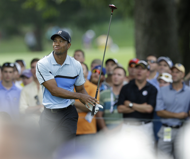 Tiger Woods watches his tee shot on the 18th hole during the first round of the PGA Championship golf tournament at Oak Hill Country Club, Thursday in Pittsford, N.Y.