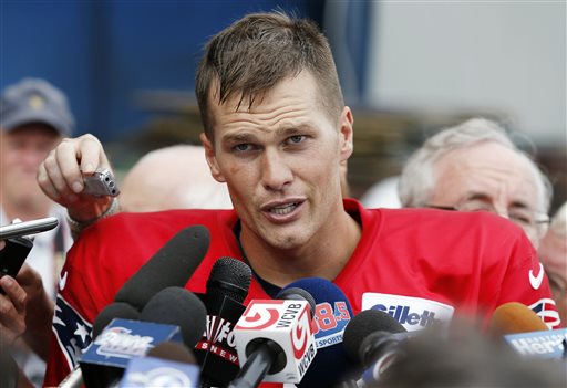 New England Patriots quarterback Tom Brady talks with reporters after NFl football practice in Foxborough, Mass., Monday, Aug. 19, 2013. (AP Photo/Michael Dwyer)