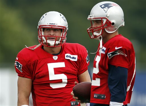 New England Patriots football quarterbacks Tim Tebow, left, and Tom Brady chat during team practice in Foxborough, Mass., on Monday.