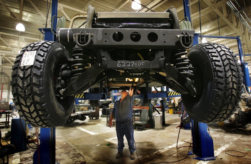 In this 2005 file photo, a mechanic inspects the underside of a refurbished Humvee at the Maine Military Authority in Limestone. The Maine Military Authority is laying off 140 people beginning in October because of the drawdown of troops and equipment in Iraq and Afghanistan. (AP Photo/Robert F. Bukaty)