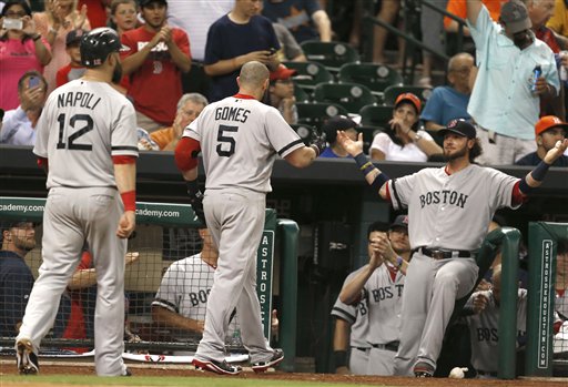 Boston Red Sox's Jarrod Saltalamacchia, right, welcomes Jonny Gomes (5) and Mike Napoli (12) back to the dugout after Gomes hit a three-run homer against the Houston Astros in the sixth inning of a baseball game Tuesday, Aug. 6, 2013, in Houston. (AP Photo/Pat Sullivan) Minute Maid Park