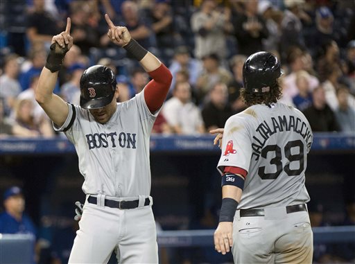 Boston Red Sox teammates Jacoby Ellsbury, left, and Jarrod Saltalamacchia celebrate after scoring the game runs to defeat the Toronto Blue Jays during the eleventh inning of a baseball game in Toronto on Tuesday, August 13, 2013. (AP Photo/The Canadian Press, Nathan Denette) Blue Jays;athlete;athletes;athletic;athletics;Canada;Canadian;Center;Centre;competative;compete;competing;competition;competitions;event;game;Jays;League;Major;MLB;pro;professional;Rogers;sport;sporting;sports;Toronto;baseball;American;AL;2013