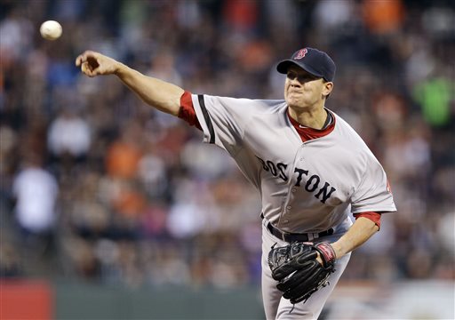 Boston Red Sox pitcher Jake Peavy delivers a pitch during a game against the Giants on Tuesday in San Francisco. Thanks to a payroll drop from about $173 million to about $150 million this season, the Red Sox have had the flexibility to add free agents and to acquire right-hander Peavy at this year's trade deadline.