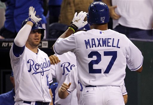 Kansas City Royals' Justin Maxwell (27) is congratulated by Brett Hayes (12) after hitting a home run in the eighth inning of a baseball game against the Boston Red Sox at Kauffman Stadium in Kansas City, Mo., Thursday, Aug. 8, 2013. (AP Photo/Colin E. Braley)