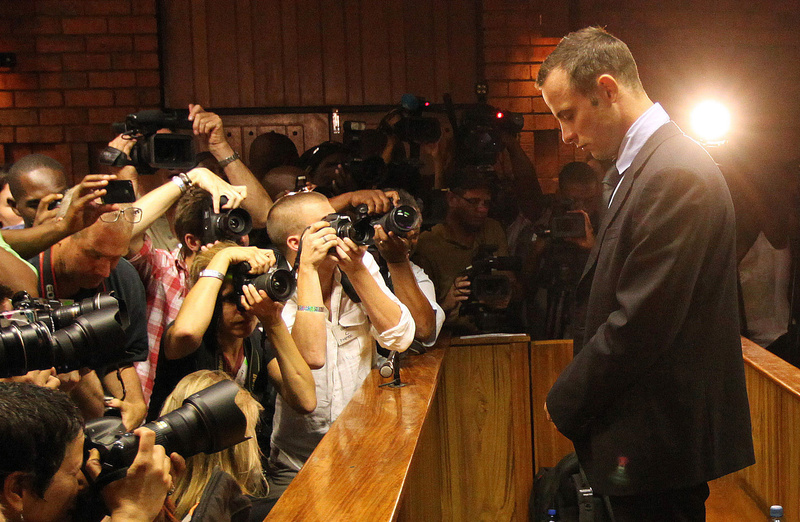 Photographers take pictures of Olympic athlete Oscar Pistorius in February as he stands in the dock during a bail hearing in Pretoria, South Africa.