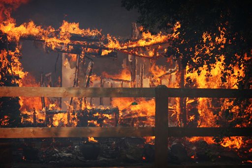 Multiple structures burn in the Poppet Flats area as the Silver Fire roared through the area along Highway 243 between Banning and Idyllwild, Calif. on Wednesday.