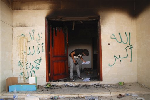 In this Sept. 12, 2012, photo, a man looks at documents at the U.S. consulate in Benghazi, Libya, after an attack that killed four Americans, including Ambassador Chris Stevens.
