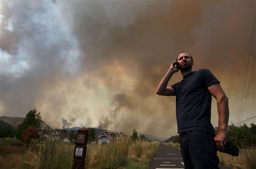 Kevin Bullock, of Bellevue, Idaho, watches smoke from the 64,000 acre Beaver Creek Fire on Friday, north of Hailey, Idaho. A number of residential neighborhoods have been evacuated because of the blaze.