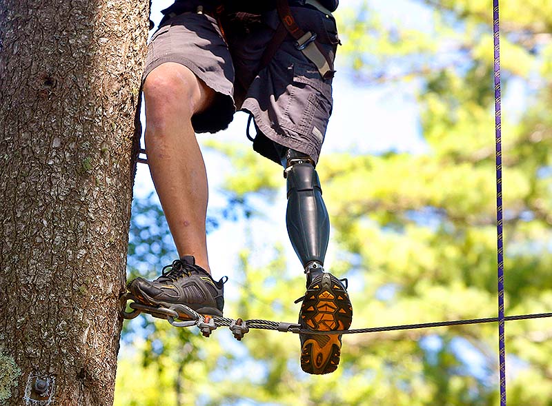 Roy Mitchell, of the Army’s 10th Mountain Division, maneuvers through the ropes course Saturday during Maine Adaptive Sports & Recreation’s ninth annual Veterans No Boundaries summer program at Camp Wavus on Damariscotta Lake in Jefferson.